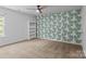 Bedroom with built in bookshelf and accent wall at 2021 Tarzi Ln, Charlotte, NC 28215