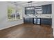 Open dining area featuring dark blue cabinetry, marble countertops, modern lighting, and a built-in wine cooler at 2021 Tarzi Ln, Charlotte, NC 28215