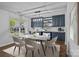 Bright dining room features custom bar with marble counters and wine cooler, and modern light fixture at 2021 Tarzi Ln, Charlotte, NC 28215