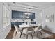 Bright dining room features custom bar with marble counters and wine cooler, and modern light fixture at 2021 Tarzi Ln, Charlotte, NC 28215