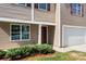 Close-up of a charming home's entrance, highlighting the front door, and well-maintained landscaping at 2021 Tarzi Ln, Charlotte, NC 28215