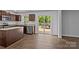 The kitchen has brown cabinets, stainless steel appliances, and a view of the deck at 2021 Tarzi Ln, Charlotte, NC 28215
