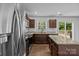 Kitchen featuring stainless steel appliances, dark cabinets, granite countertops, and a center island at 2021 Tarzi Ln, Charlotte, NC 28215