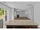 Open concept kitchen featuring dark cabinets, granite countertops, leading to a living room with a fireplace at 2021 Tarzi Ln, Charlotte, NC 28215