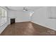 Bright living room featuring a fireplace, wood flooring, and a modern ceiling fan at 2021 Tarzi Ln, Charlotte, NC 28215