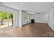 Bright living room with a fireplace, wood floors, and sliding glass doors to the deck at 2021 Tarzi Ln, Charlotte, NC 28215