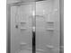 A pristine glass enclosed shower with shower head and built-in shelving at 2021 Tarzi Ln, Charlotte, NC 28215