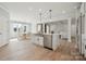 Open kitchen with a large island, stainless steel appliances, and a seamless flow to the living spaces at 203 Balboa St, Matthews, NC 28104