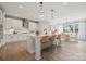 Spacious kitchen with white cabinetry, stainless steel appliances, island with seating, and an adjacent dining area at 203 Balboa St, Matthews, NC 28104