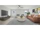 Relaxing living room with a leather sofa, chairs, large windows, and a sleek entertainment center at 203 Balboa St, Matthews, NC 28104