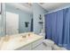 Classic bathroom featuring a blue shower curtain, anchor decor, and a white vanity with sink at 2206 Waters Trail Dr, Charlotte, NC 28216