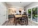Cozy dining area with wood floors, view to living room, and access to the backyard through sliding glass doors at 2206 Waters Trail Dr, Charlotte, NC 28216