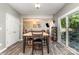 Dining room with an adjacent living room, sliding glass doors, and wood floors at 2206 Waters Trail Dr, Charlotte, NC 28216