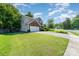 Two-story home with a brick accent, green shutters, and manicured lawn on a beautiful street at 2206 Waters Trail Dr, Charlotte, NC 28216
