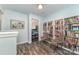 Hallway with a bookcase featuring a view into a blue bedroom at 2206 Waters Trail Dr, Charlotte, NC 28216
