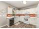 Efficient kitchen with white cabinets, stainless steel sink, and decorative backsplash at 2206 Waters Trail Dr, Charlotte, NC 28216