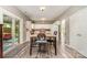 Open floor plan showcasing the kitchen and dining area with white cabinets, wooden table and modern appliances at 2206 Waters Trail Dr, Charlotte, NC 28216