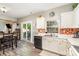 Bright kitchen featuring white cabinets, colorful backsplash, stainless steel sink and sliding door to patio at 2206 Waters Trail Dr, Charlotte, NC 28216