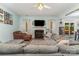 Bright living room with wood-look floors, a large sectional sofa, fireplace and backyard view at 2206 Waters Trail Dr, Charlotte, NC 28216