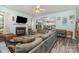 Bright living room with wood-look floors, a sectional sofa, fireplace and a kitchen view at 2206 Waters Trail Dr, Charlotte, NC 28216