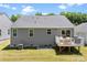Backyard view of a two story gray house with a small deck, some yard space, and an AC unit at 2217 Goldwood Dr, Charlotte, NC 28215