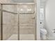 Bathroom showcases a tiled shower with glass doors and sleek fixtures, creating a spa-like experience at 2217 Goldwood Dr, Charlotte, NC 28215
