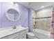 Cozy bathroom with single sink vanity, tiled shower over tub and colorful accents at 2217 Goldwood Dr, Charlotte, NC 28215