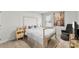 Bright bedroom features a platform bed, chair, and stylish decor, creating a warm and inviting space at 2217 Goldwood Dr, Charlotte, NC 28215