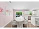 Charming dining area with a modern table, plush chairs, and a view of the backyard at 2217 Goldwood Dr, Charlotte, NC 28215