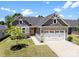 Charming single-Gathering home with a two-car garage, stone accents and a well-maintained front yard at 2217 Goldwood Dr, Charlotte, NC 28215
