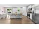 Bright, modern kitchen with stainless steel appliances, a large island, and sleek white cabinetry at 2217 Goldwood Dr, Charlotte, NC 28215