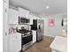 Well-equipped kitchen with stainless steel appliances, white cabinets, and a stylish backsplash at 2217 Goldwood Dr, Charlotte, NC 28215