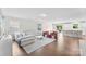 Open-concept living area featuring a cozy couch, stylish chairs, and seamless flow to the dining area at 2217 Goldwood Dr, Charlotte, NC 28215