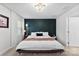 Stylish bedroom featuring a dark accent wall, large bed, and modern lighting fixtures at 2217 Goldwood Dr, Charlotte, NC 28215