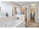 Well-lit bathroom features a soaking tub, enclosed glass shower, and decorative accents at 2522 Richland Balsam Dr # 450, Fort Mill, SC 29715