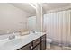 Bright bathroom boasts a double sink vanity with a large mirror and a shower tub with curtain at 2522 Richland Balsam Dr # 450, Fort Mill, SC 29715