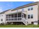 Exterior view of the home showcasing a screened-in porch with access to the backyard and white stairs at 2522 Richland Balsam Dr # 450, Fort Mill, SC 29715