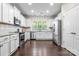 Modern kitchen with stainless appliances, granite counters, white cabinets, and hardwood flooring at 2522 Richland Balsam Dr # 450, Fort Mill, SC 29715