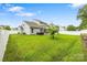 Landscaped backyard featuring a well-maintained lawn, privacy fence, and outdoor spa at 3053 Riker St, Clover, SC 29710