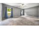 Bright bedroom with carpet flooring, ceiling fan, and natural light through windows with stylish blue curtains at 3053 Riker St, Clover, SC 29710