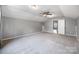 Spacious bedroom with neutral walls, plush carpeting, ceiling fan, and an open doorway at 3053 Riker St, Clover, SC 29710