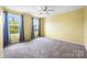 Bedroom with plush carpeting, two windows with gray curtains, and neutral yellow walls at 3053 Riker St, Clover, SC 29710