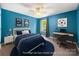 Comfortable bedroom with blue accent walls, natural light, a desk, and a ceiling fan provides a relaxed space at 3053 Riker St, Clover, SC 29710