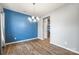 Elegant dining room with hardwood floors, modern chandelier, and a stylish blue accent wall at 3053 Riker St, Clover, SC 29710