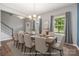 Bright dining room with large windows, modern chandelier, and seating for ten offers ample space for Gathering gatherings at 3053 Riker St, Clover, SC 29710