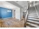 Elegant dining room with hardwood floors, modern chandelier, and a stylish blue accent wall at 3053 Riker St, Clover, SC 29710