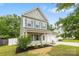 Charming two-story home with gray siding, a well-manicured lawn, and a two-car garage at 3053 Riker St, Clover, SC 29710