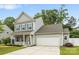 Charming two-story home with gray siding, a well-manicured lawn, and a two-car garage at 3053 Riker St, Clover, SC 29710