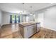 Modern kitchen island featuring granite countertops, stainless steel sink, and ample storage space at 3053 Riker St, Clover, SC 29710
