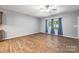 Bright living room with wood floors, ceiling fan, and windows dressed with stylish blue curtains at 3053 Riker St, Clover, SC 29710